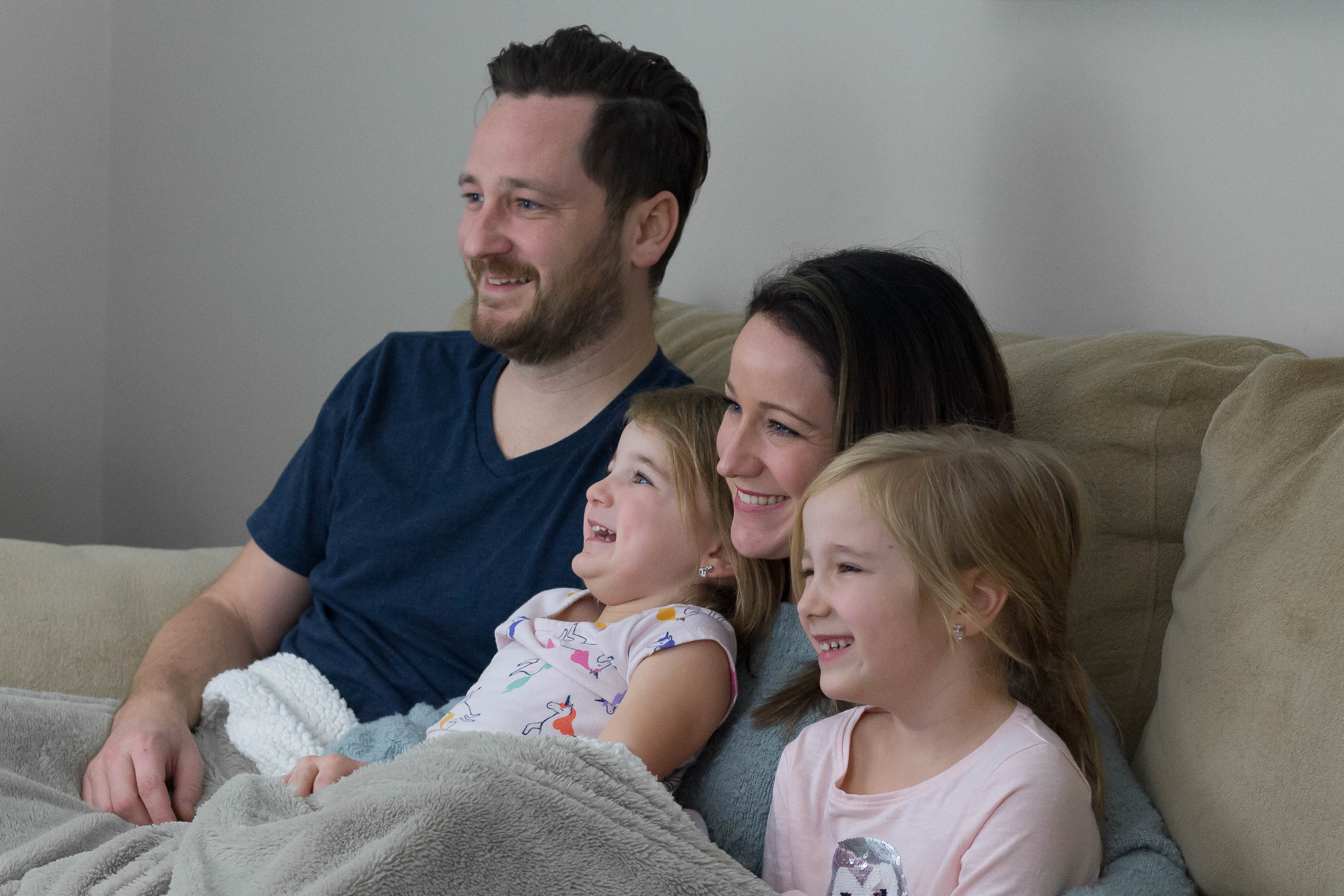 Family watching movie for movie night party for mommys movie magic